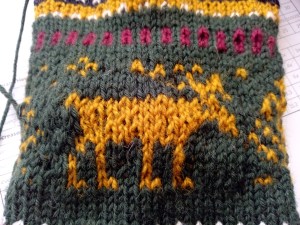a knitted yellow deer ; there are several places where the knitted deer doesn't look good and stitches are twisted 